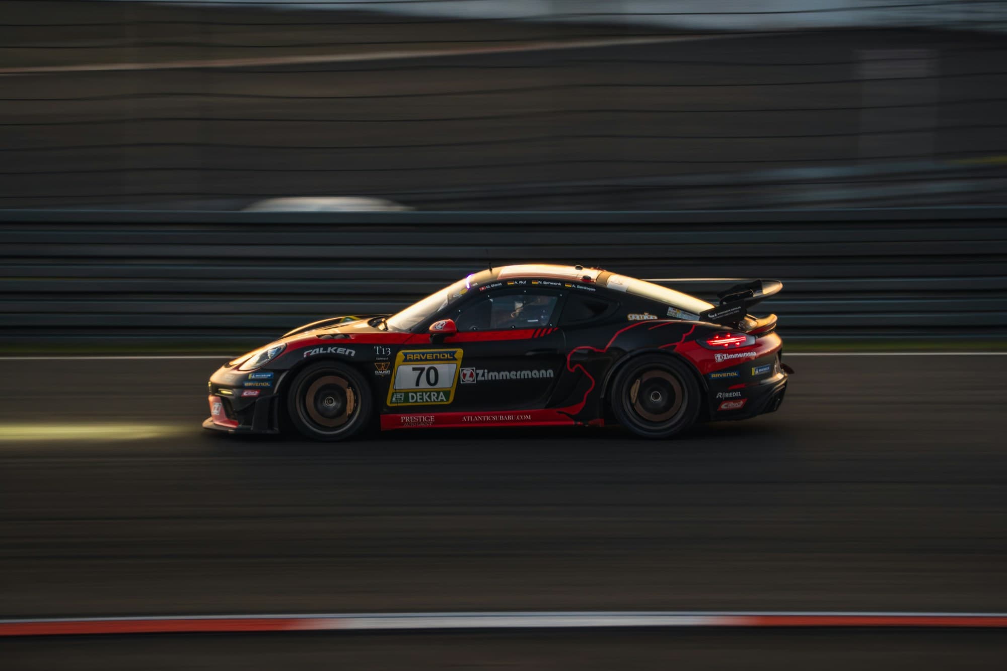 Porsche 718 GT4 race car at speed at dusk with dramatic motion blur