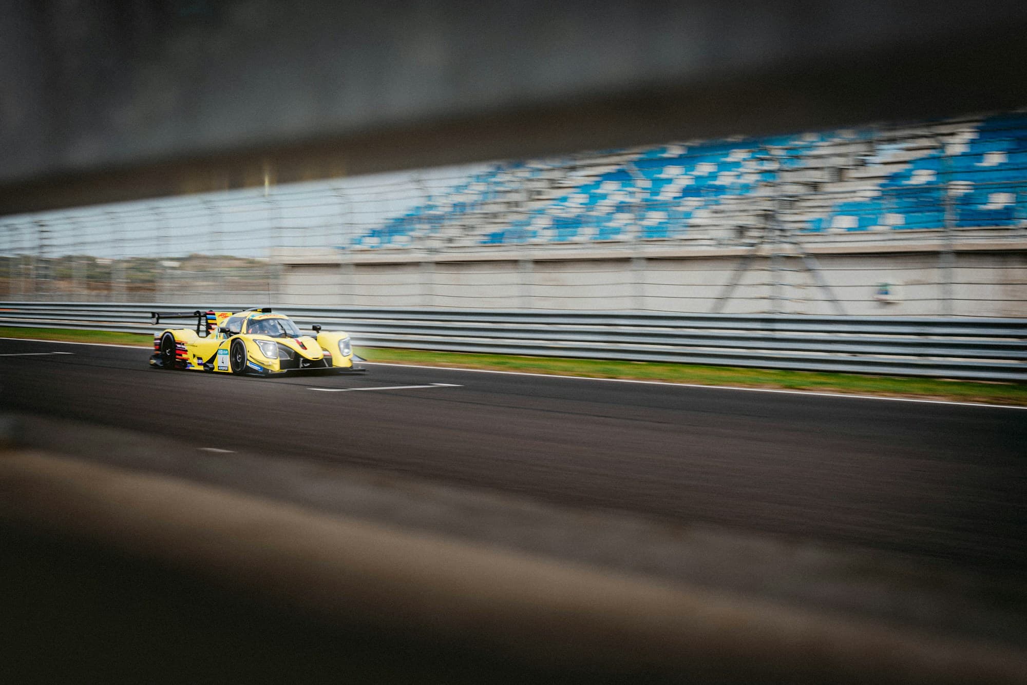 GT prototype at speed on track with motion blur