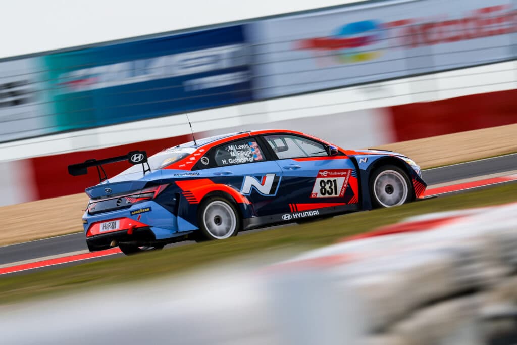 Race-prepared touring car at full speed with motion blur
